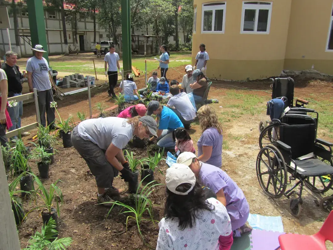 A student tending plants in the BTCV garden.