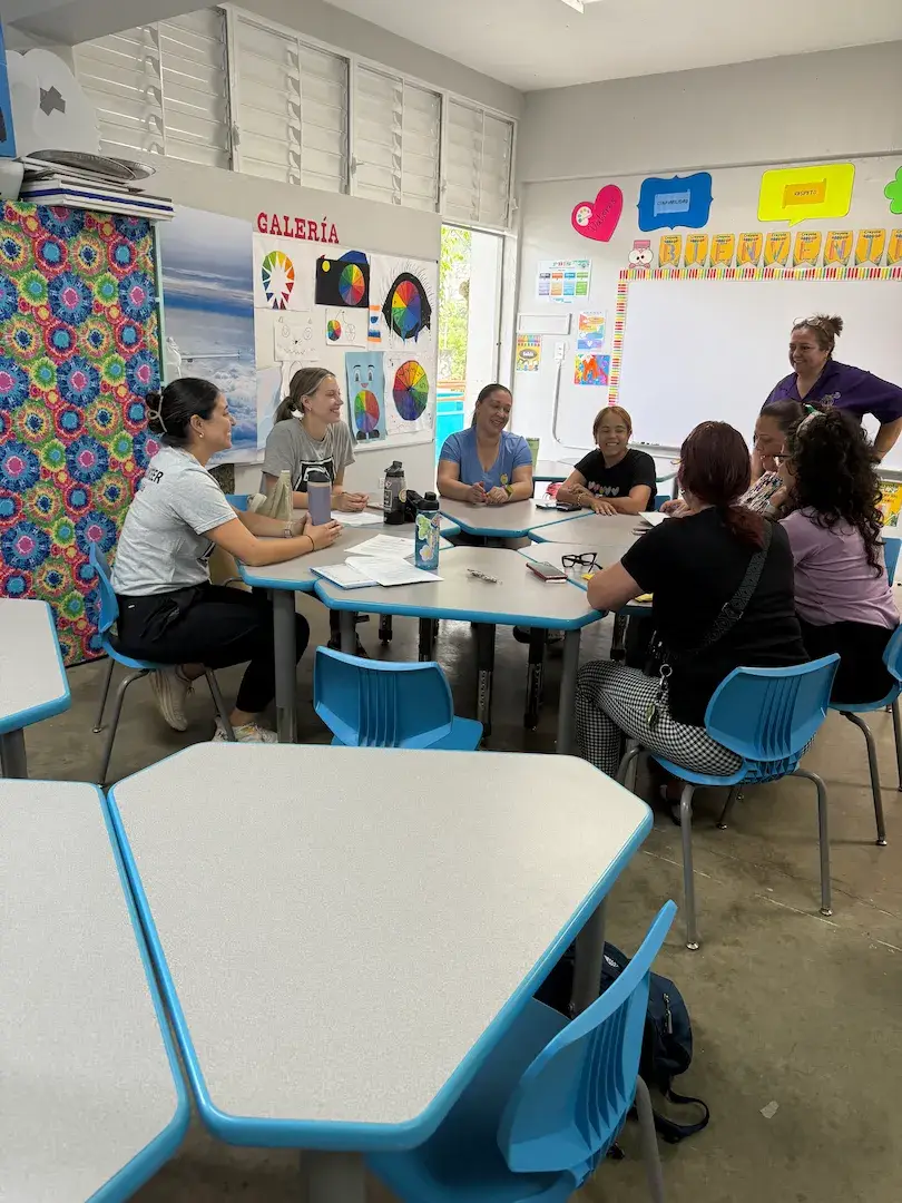 A volunteer talking and connecting with a student.