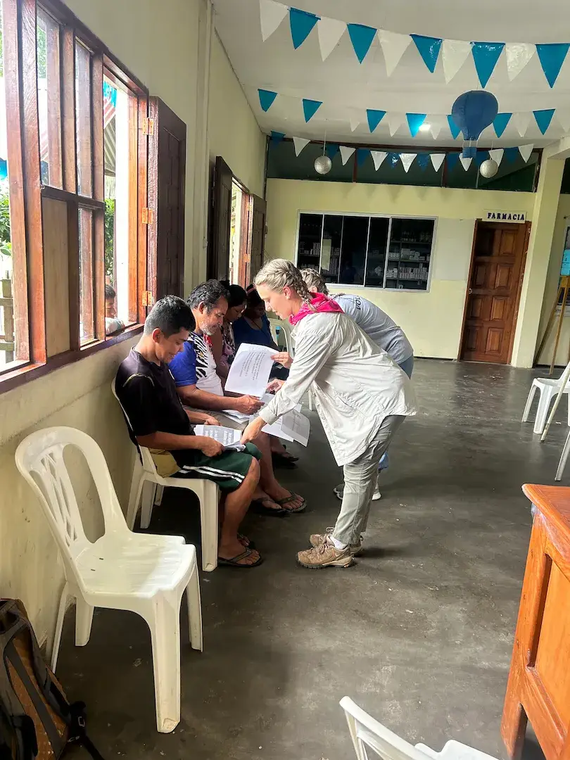 A volunteer supporting a student with their studies.
