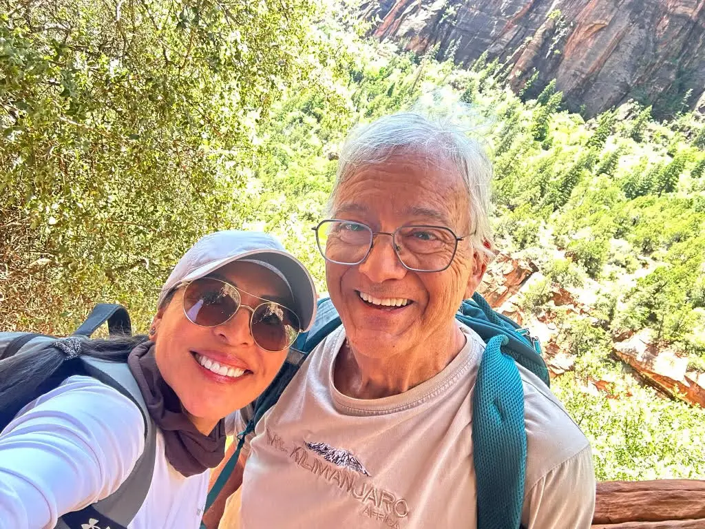 Paul and a companion smiling in a selfie on a mountain trail