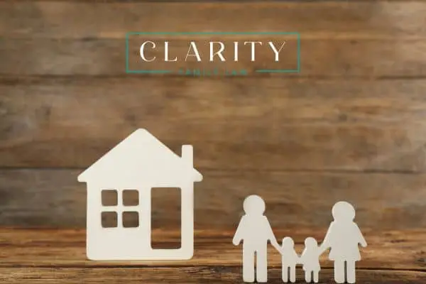 a cutout of a family and house