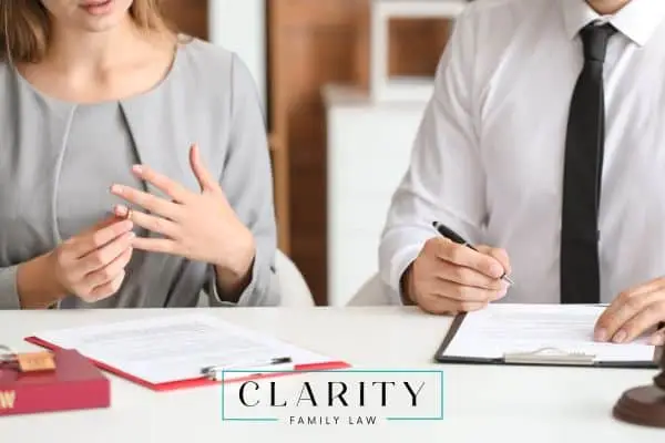 a couple signing paperwork with their annulment attorney
