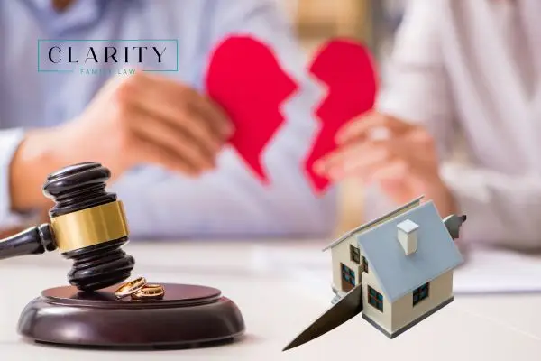 Gavel, wedding rings, and a miniature house being cut by a knife, a couple holding a broken heart, alluding to divorce and asset division.