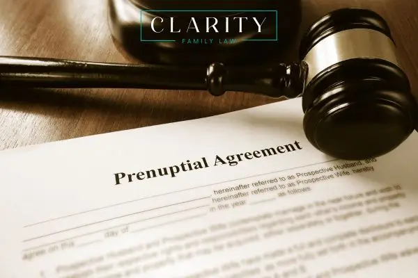a prenuptial agreement on a desk next to a gavel