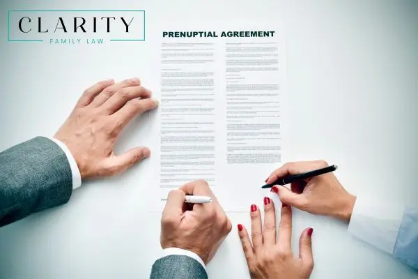a couple signing a prenuptial agreement
