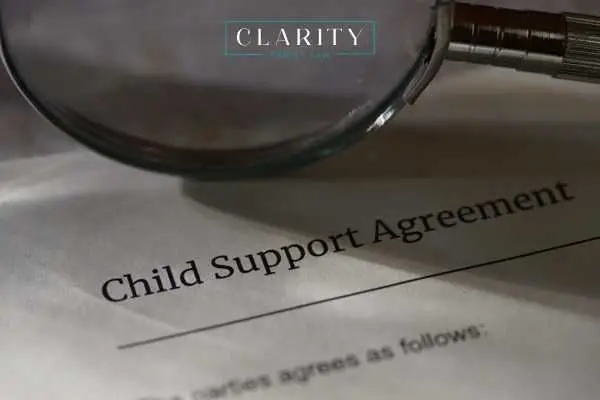 a magnifying glass and child support agreement