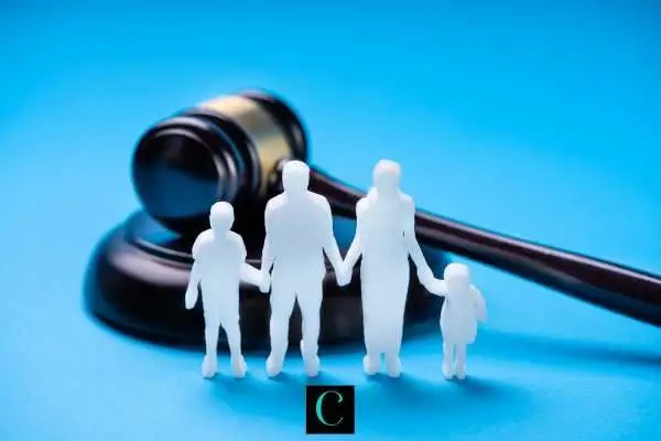 a cutout of a family in front of a gavel