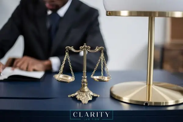 man in suit at desk with scales in front