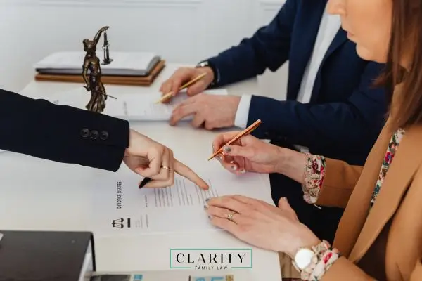 Two adults reading over child custody agreement