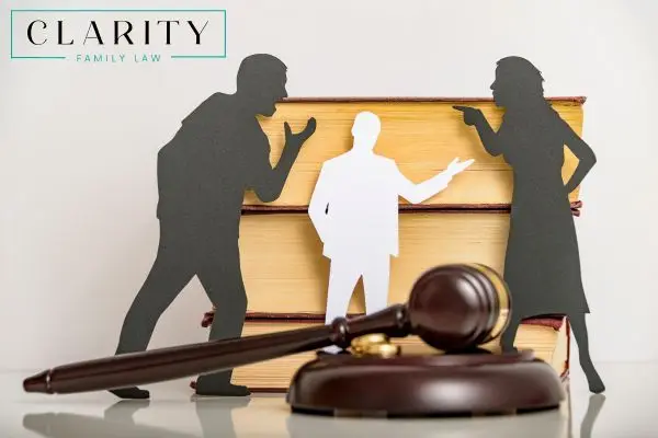 paper cut outs of parents arguing with a lawyer in between