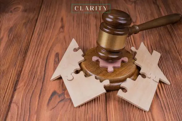 a gavel splitting a model home in two on a table