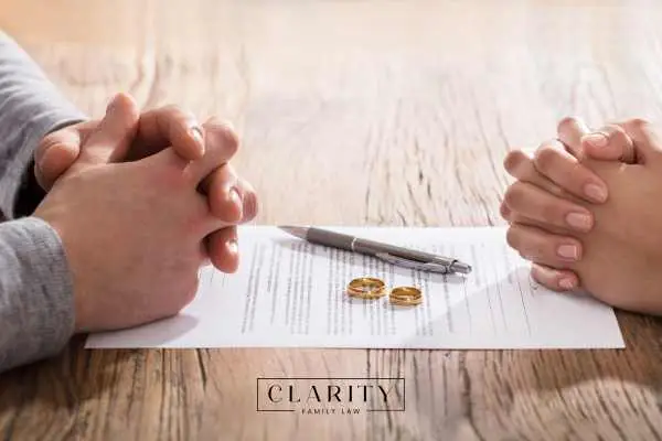 a man being given divorce papers by his wife