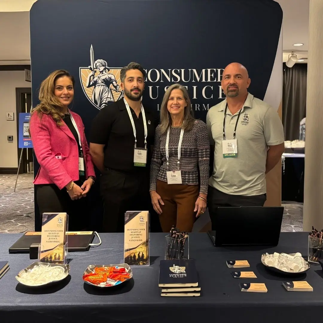 Consumer Justice Law Firm partners stand together at the NACA & NCLC conference.