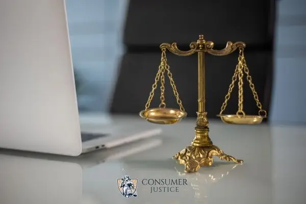 a laptop and scales on a lawyers desk