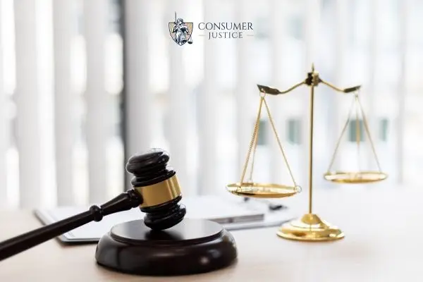 a gavel, scales, and legal documents on a desk