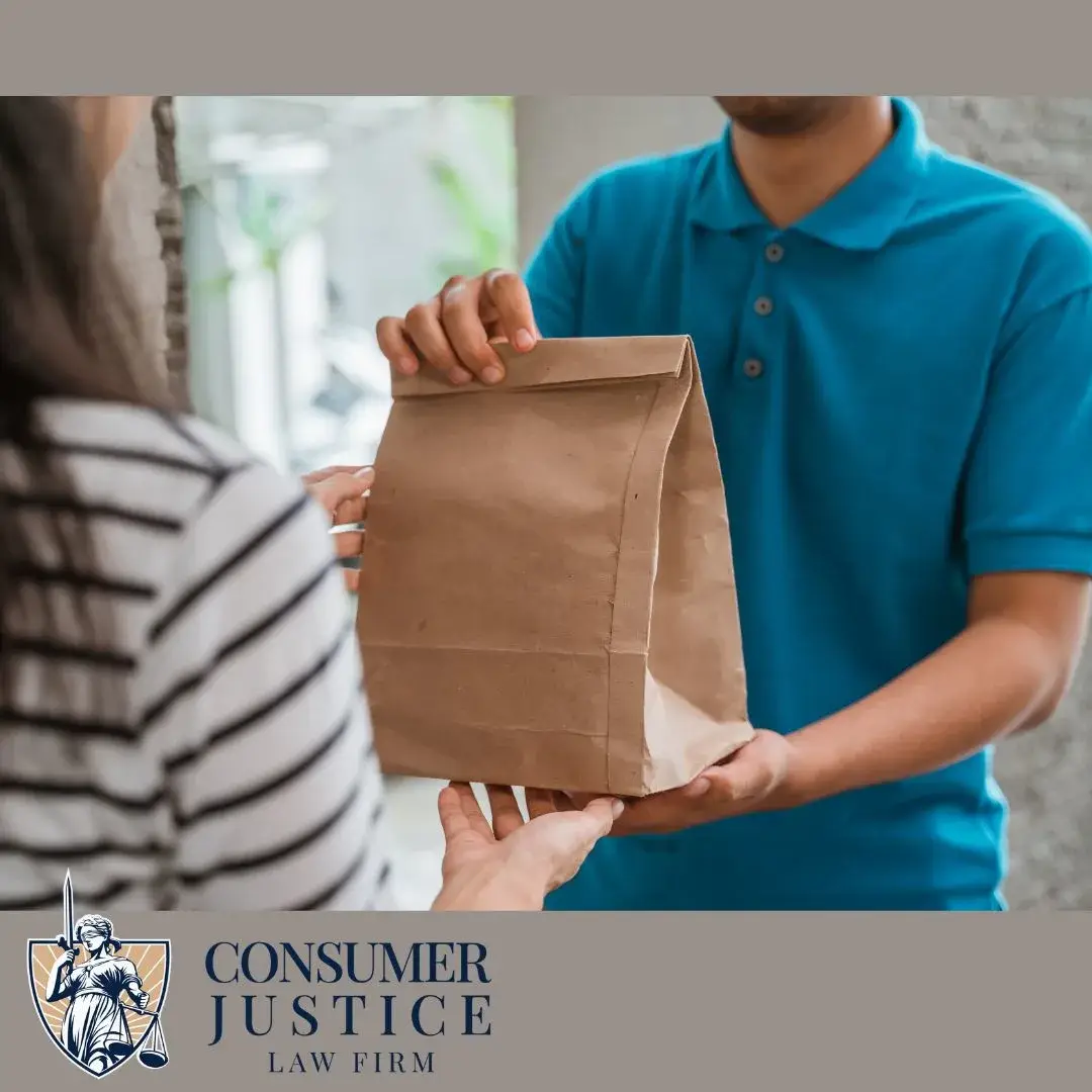 A delivery driver hands over an order after clearing errors from his DoorDash background check.