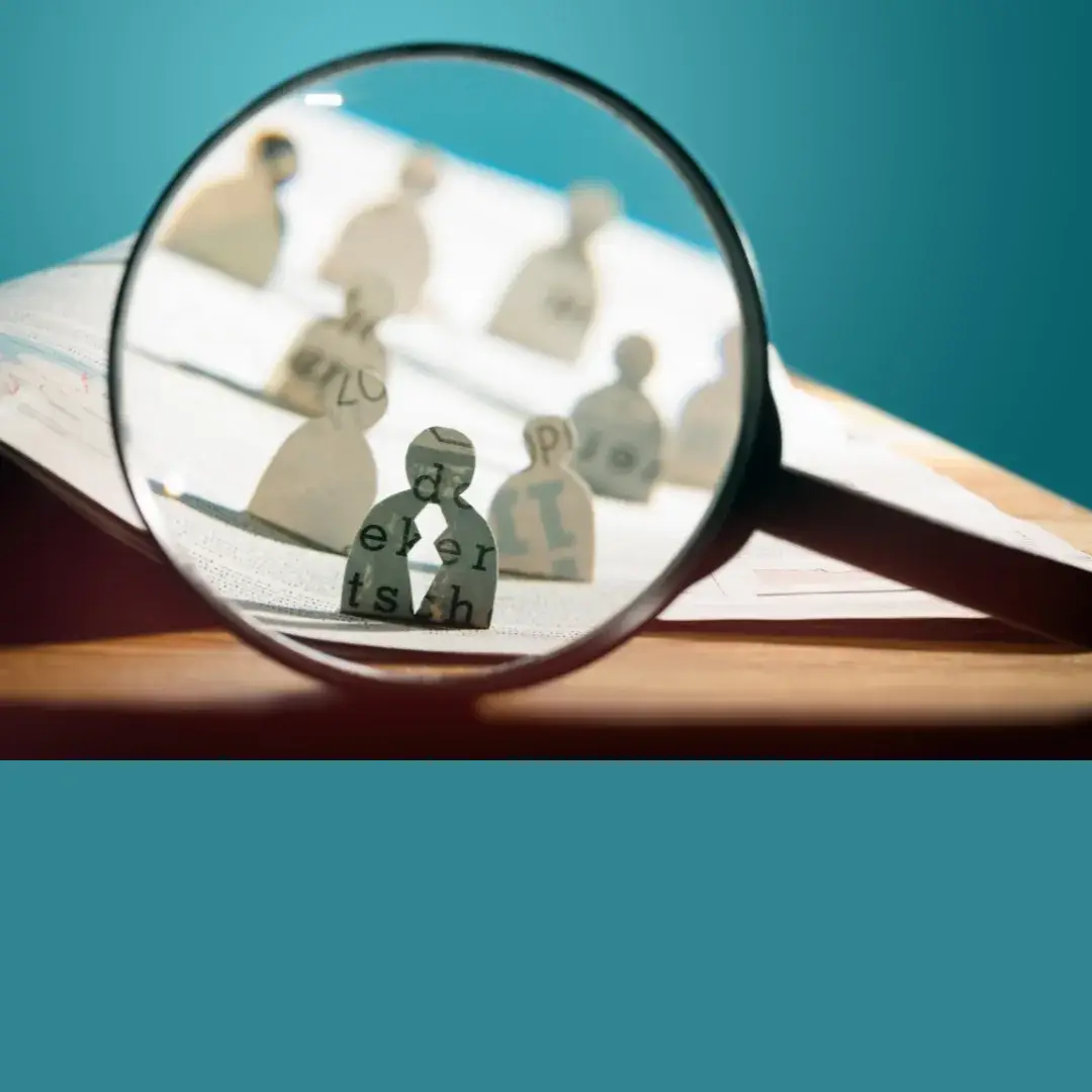 A magnifying lens brings small human shapes into focus, one with a split in it. It suggests the seriousness of HireRight background check errors.