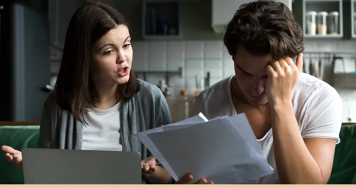 A couple is upset looking at a Checkr background check report together.
