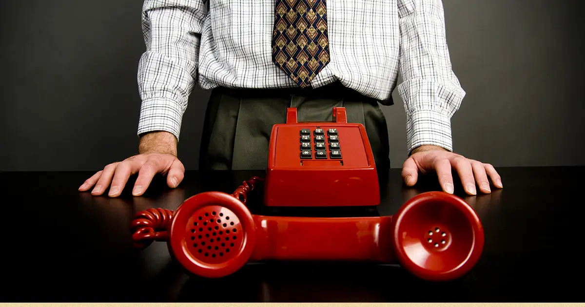 A man waits by the phone during Credit Systems International harassment.