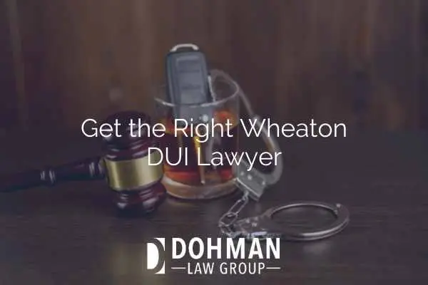 an image of car keys in a glass of alcohol, handcuffs, and a gavel on a desk