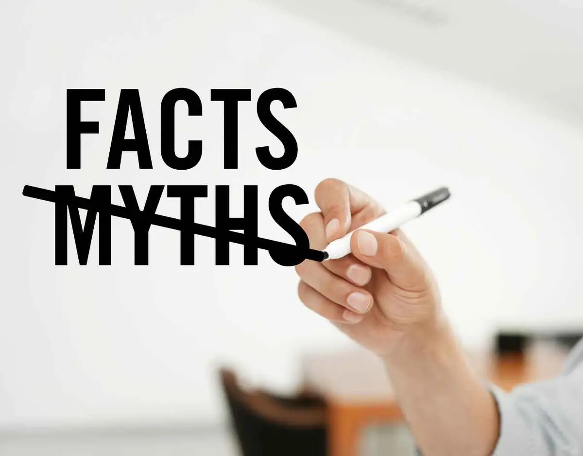 a person scratching out the word "myths" and writing the word "facts" over it