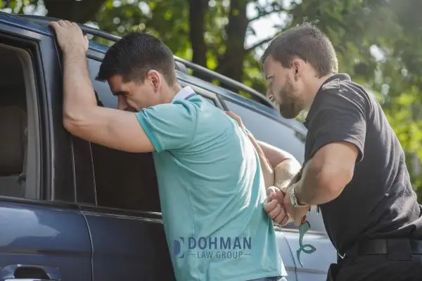 policeman arresting a man for DUI