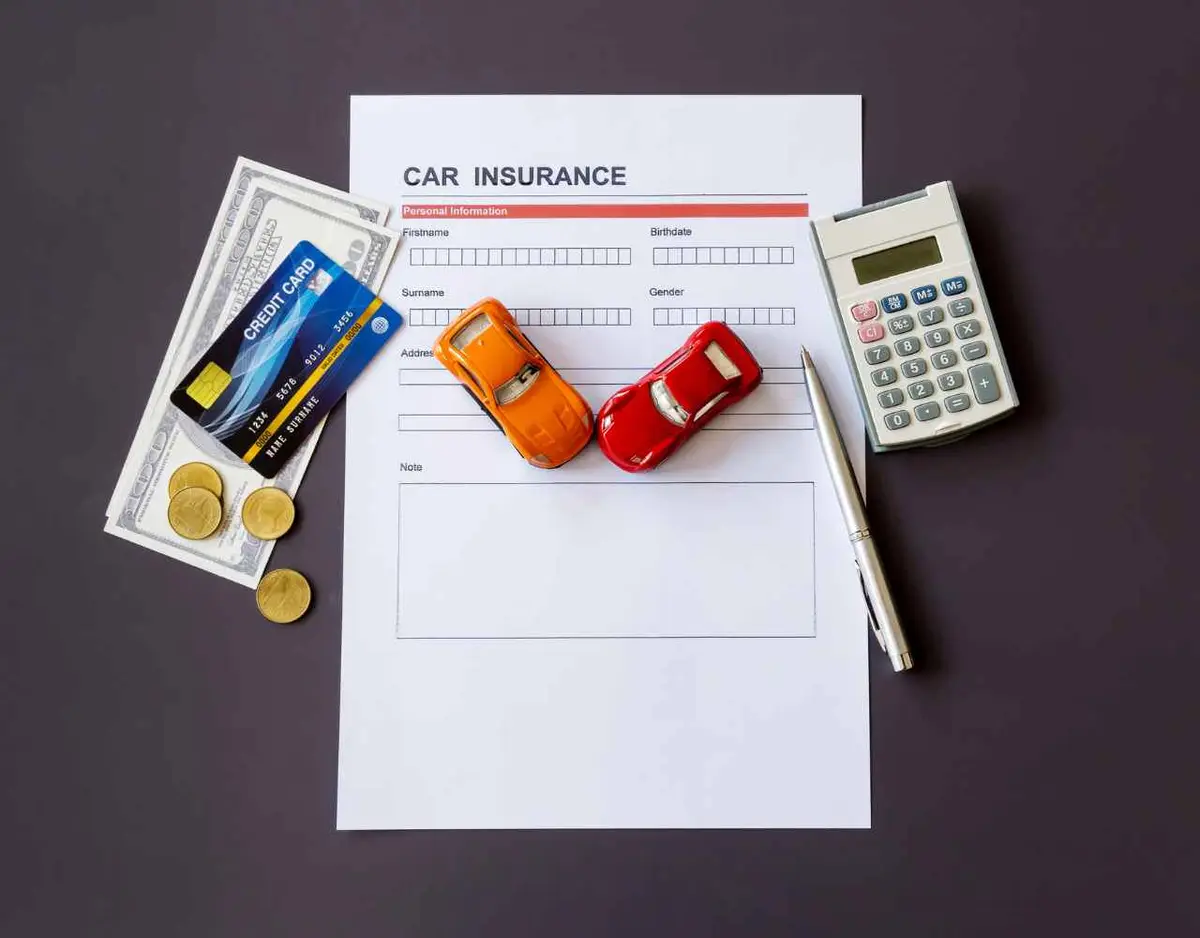 car insurance forms and money on a table