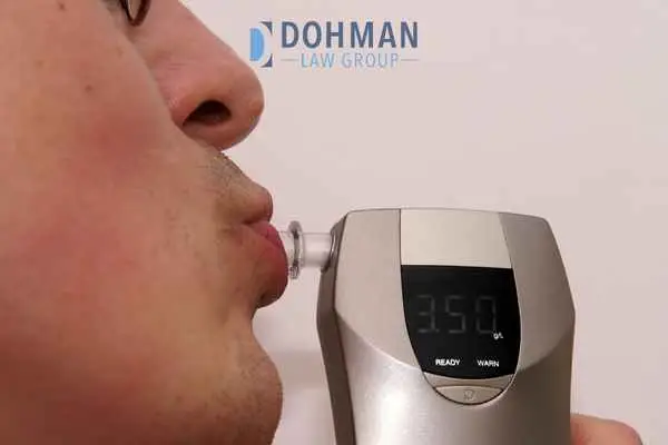 a man blowing into a breathalyzer