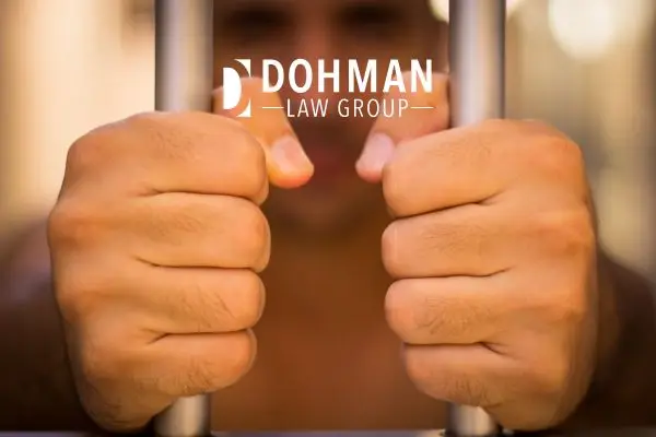 a man gripping jail cell bars from inside