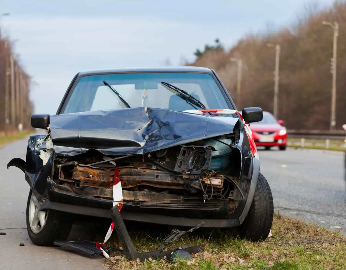 a car on the side of the road damaged from an accident