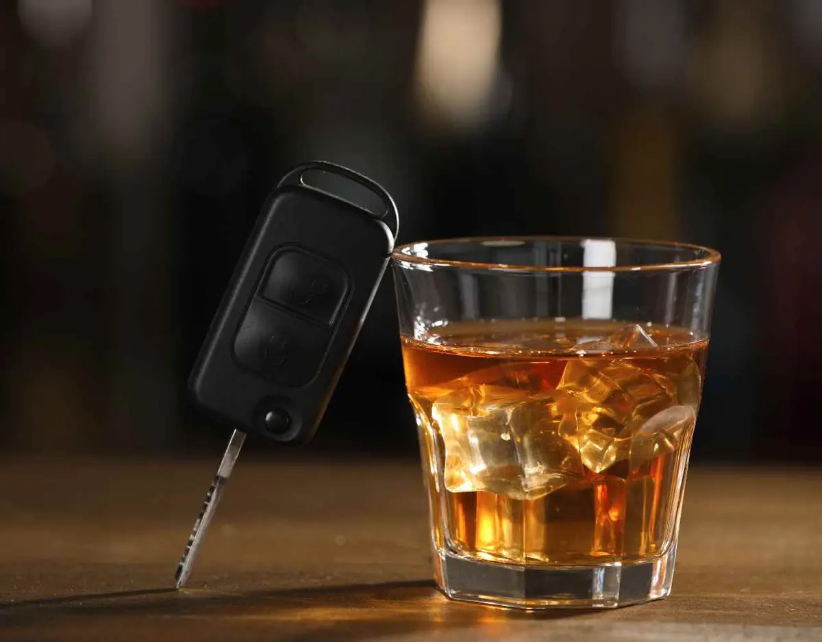 car keys and alcohol on a bar top