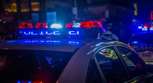 police car at night with the lights on