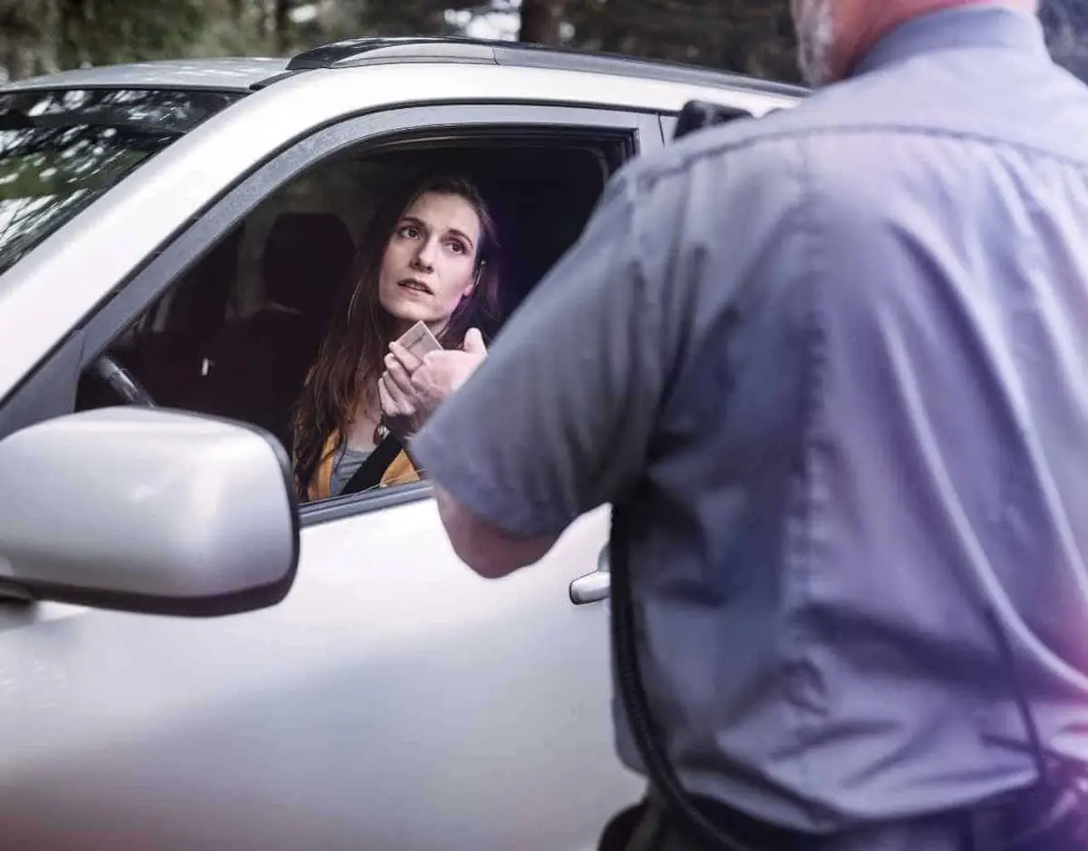 a police officer speaking to a driver after pulling them over