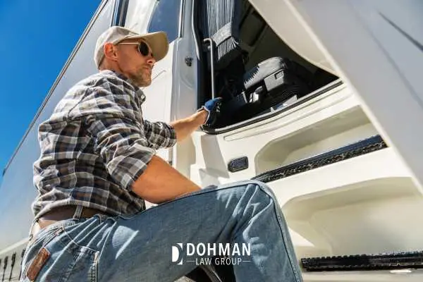 a man climbing into the cab of a truck