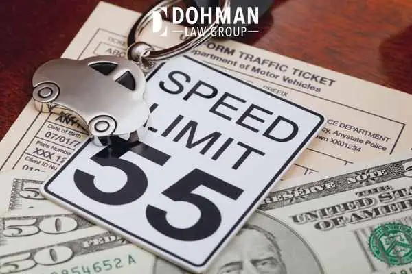 money and a speeding ticket on a desk