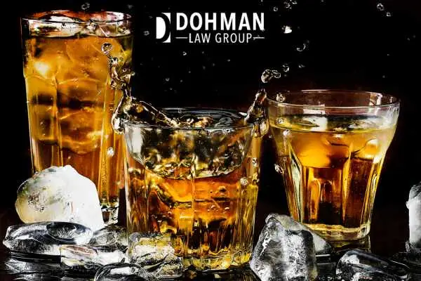 3 glasses of alcohol in front of a black backkground