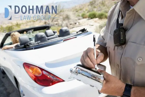 a police officer citing a ticket to a driver