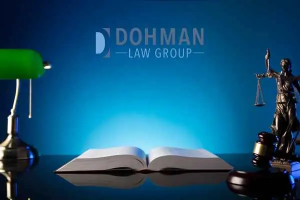 lamp, gavel, statue, and book on a desk, Statutory License Suspension in Illinois