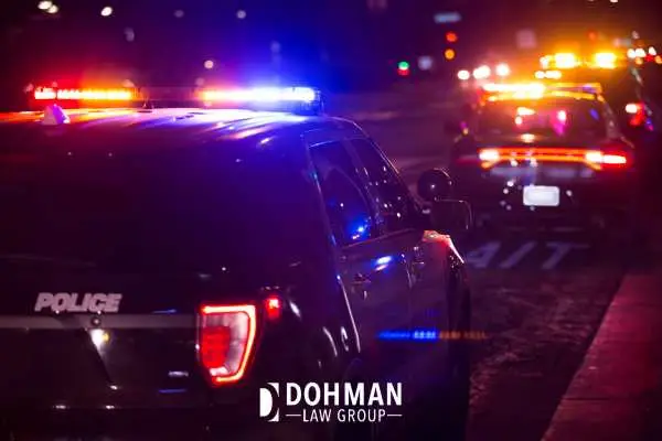 a police car pulling a driver over at night