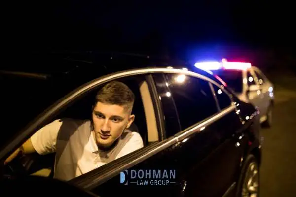 a young man being puled over for driving under the influence