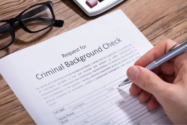 Person signing criminal background check document