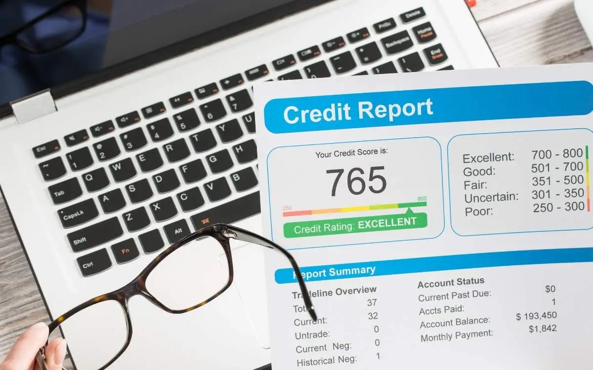 Laptop, a credit report and glasses