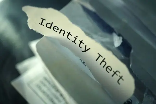 small piece of paper with identity theft written in typewriter font