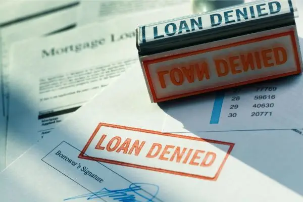 mortgage application with red stamp saying loan denied