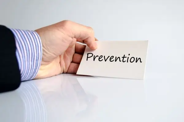 Hand holding a card that reads "Prevention.
