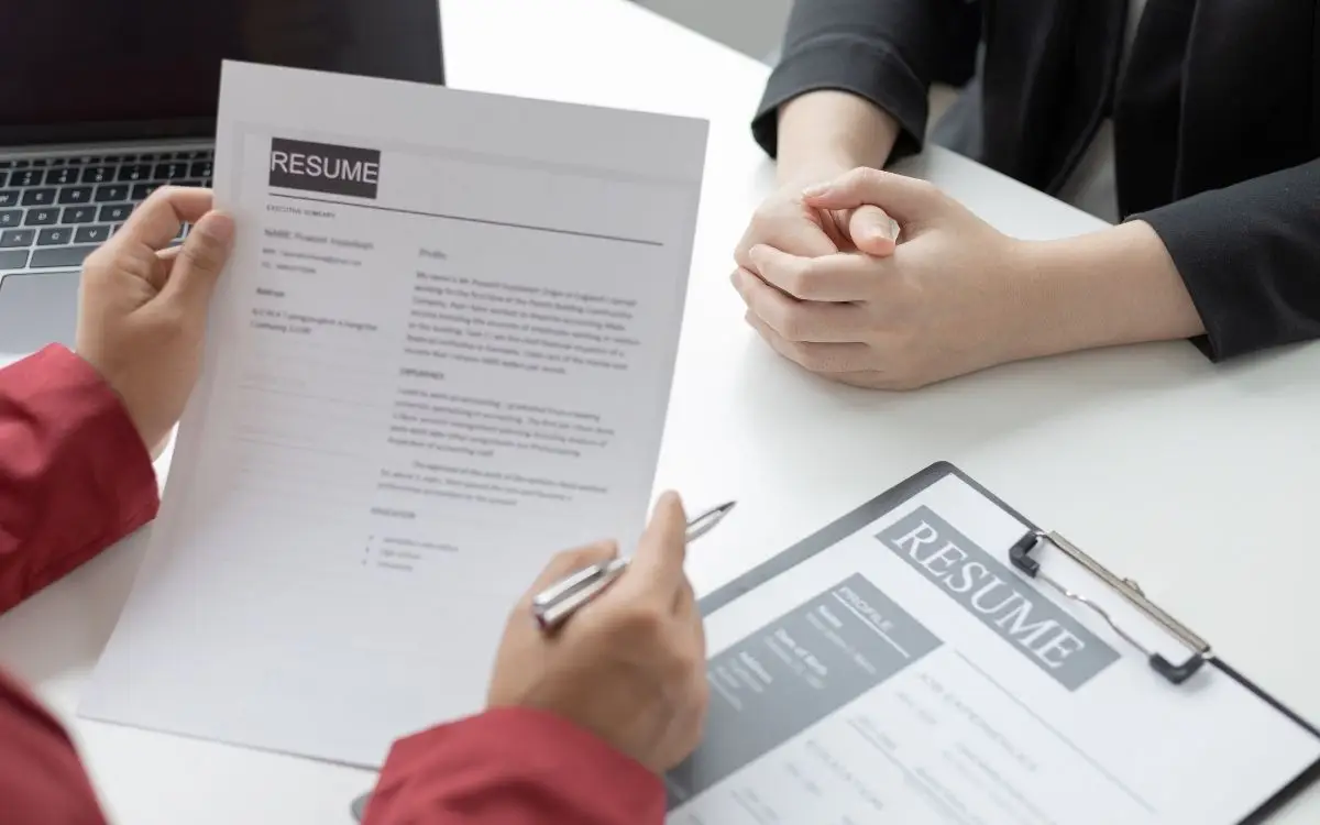 employer looking at a background check during a job interview
