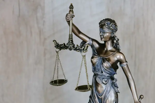 a brass statue depicting Lady Justice, a blindfolded figure holding a scale