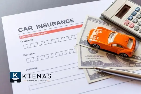 An orange toy car rests on top of several 100-dollar bills and a 