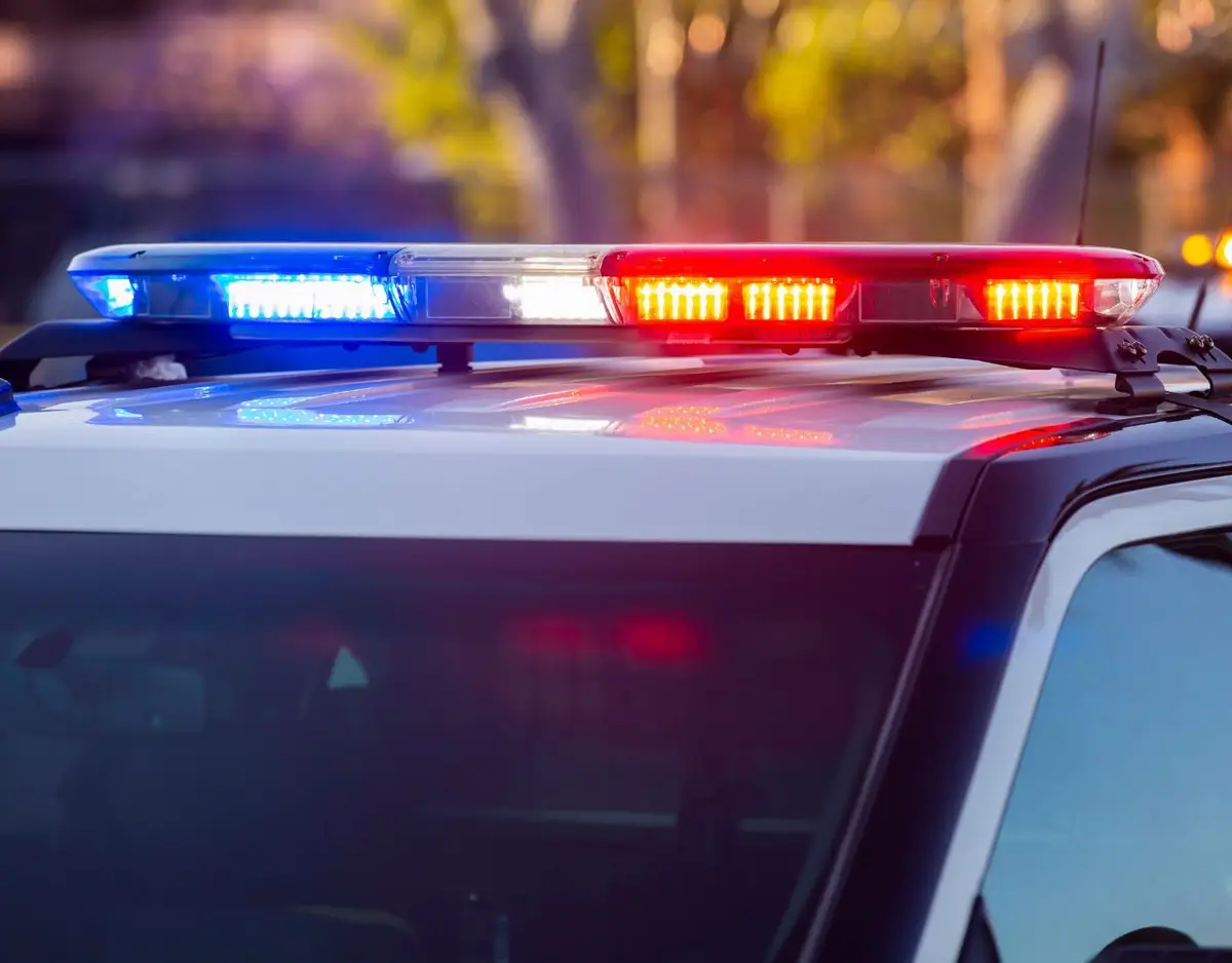 red and blue emergency light bar on top of a police cruiser