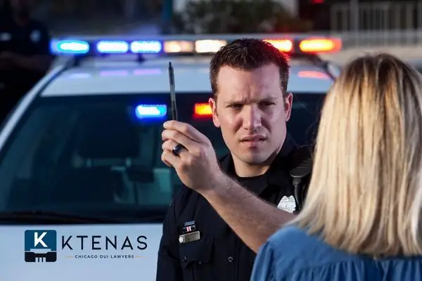 A police officer performs a field sobriety test on a woman